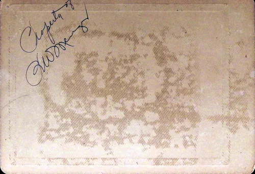 Property of (blank verso) — Card back of a photograph, mostly blank with a faint mottled pattern. Handwritten in ink at upper left: "Property of" followed by an illegible signature [?].
