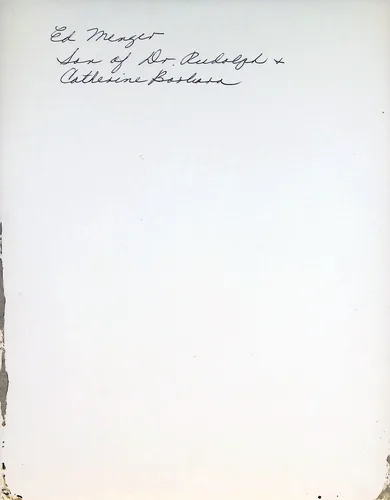 Ed Menger (identification) — Handwritten verso reading: "Ed Menger Son of Dr. Rudolph & Catherine Barbara[?]". The page is otherwise blank with damage/staining along the left edge.